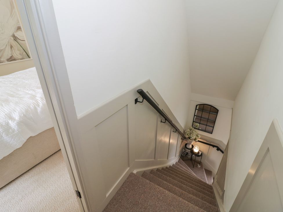 A staircase leading down with a door and window at 3 Swedish House in Walgrave