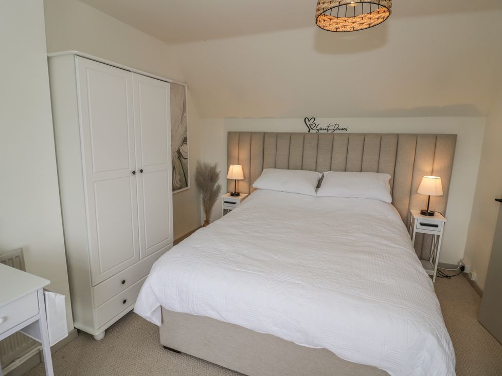 A bedroom with a bed and nightstands at 3 Swedish House in Walgrave