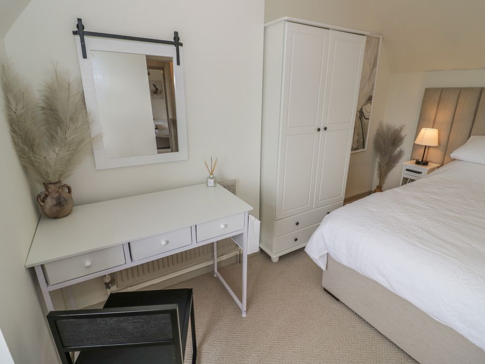 A bedroom with a desk, chair, bed and wardrobe at 3 Swedish House in Walgrave