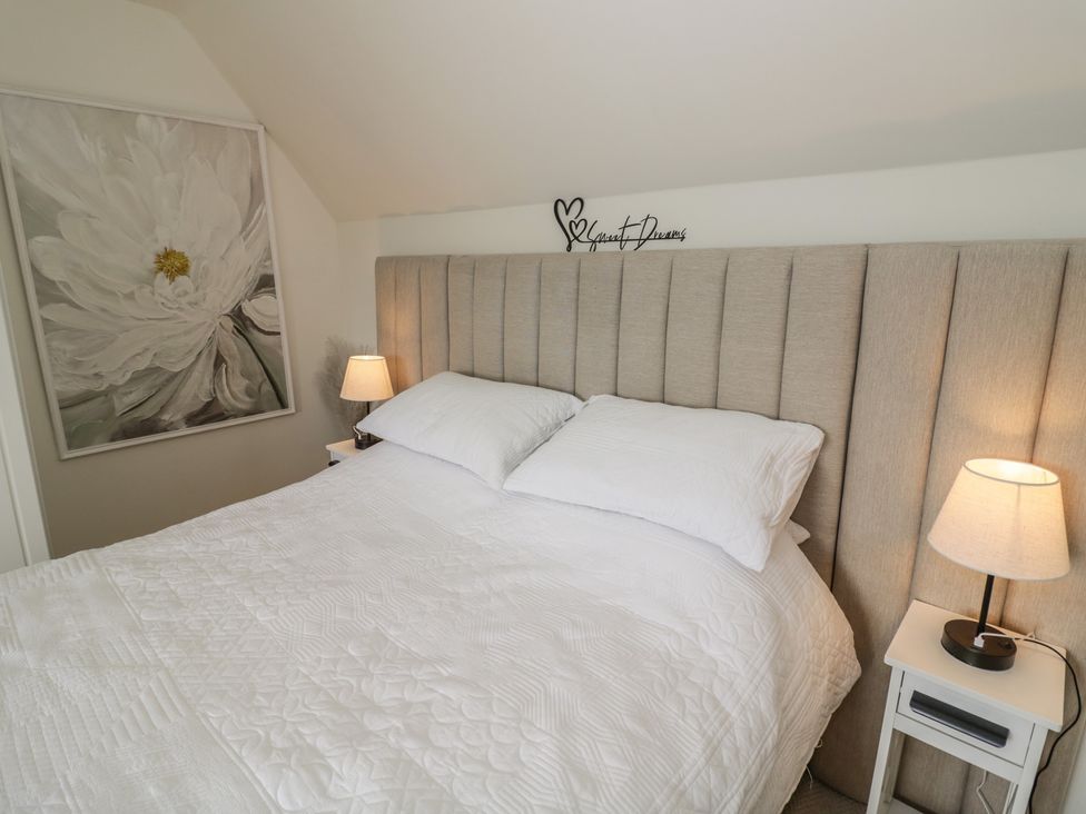 A bedroom with a bed and wall art at 3 Swedish House in Walgrave