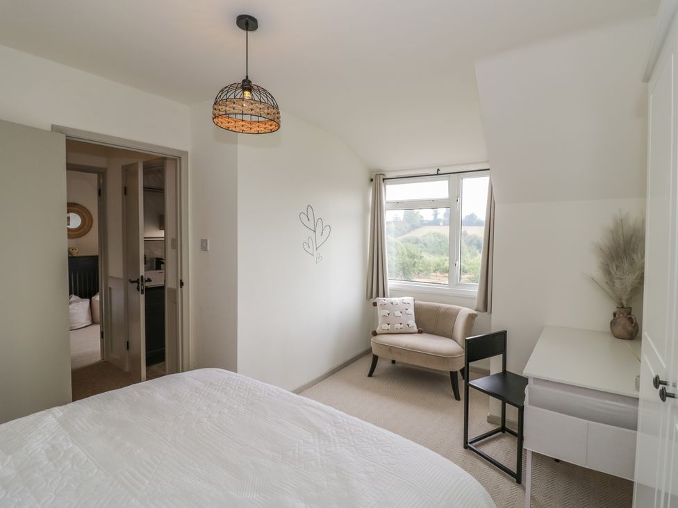 A bedroom with a bed, window, and desk at 3 Swedish House, Walgrave