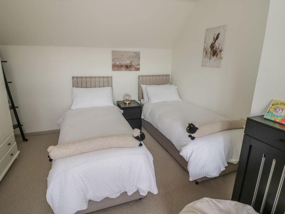 A bedroom with two beds and a nightstand at 3 Swedish House in Walgrave