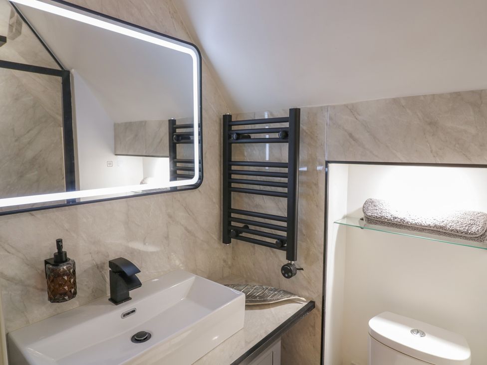 A bathroom with a sink and a mirror at 3 Swedish House in Walgrave