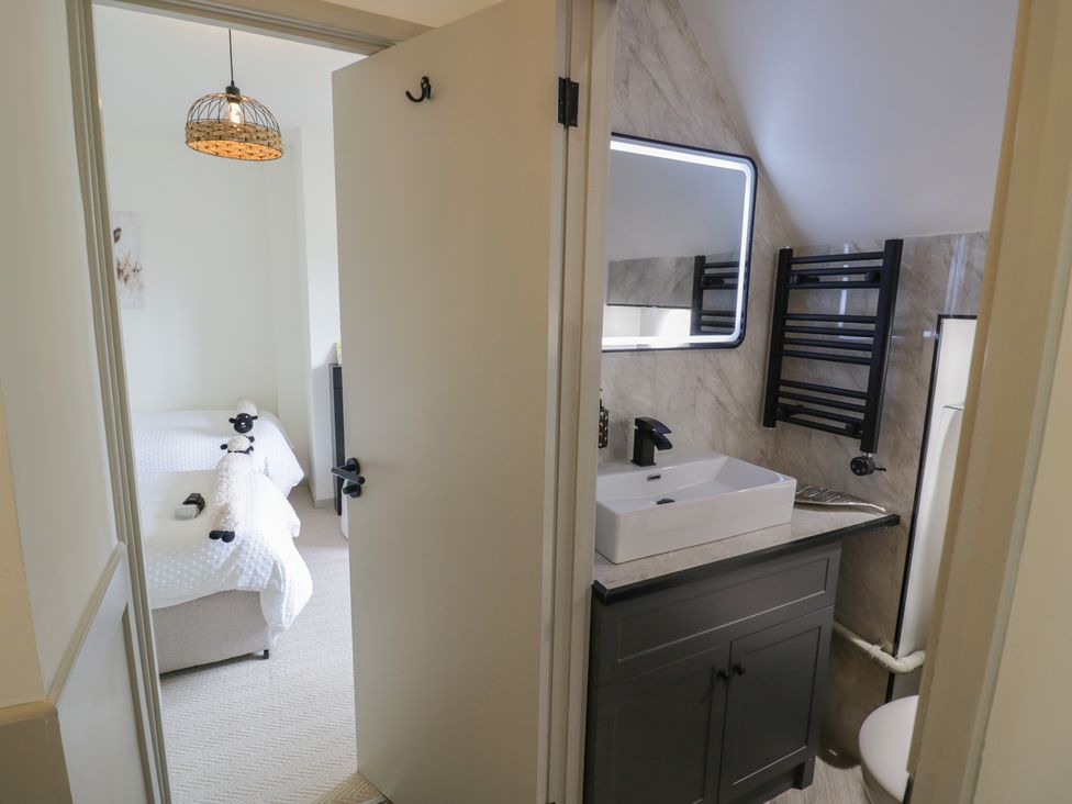 A bathroom with a sink and a towel warmer at 3 Swedish House in Walgrave