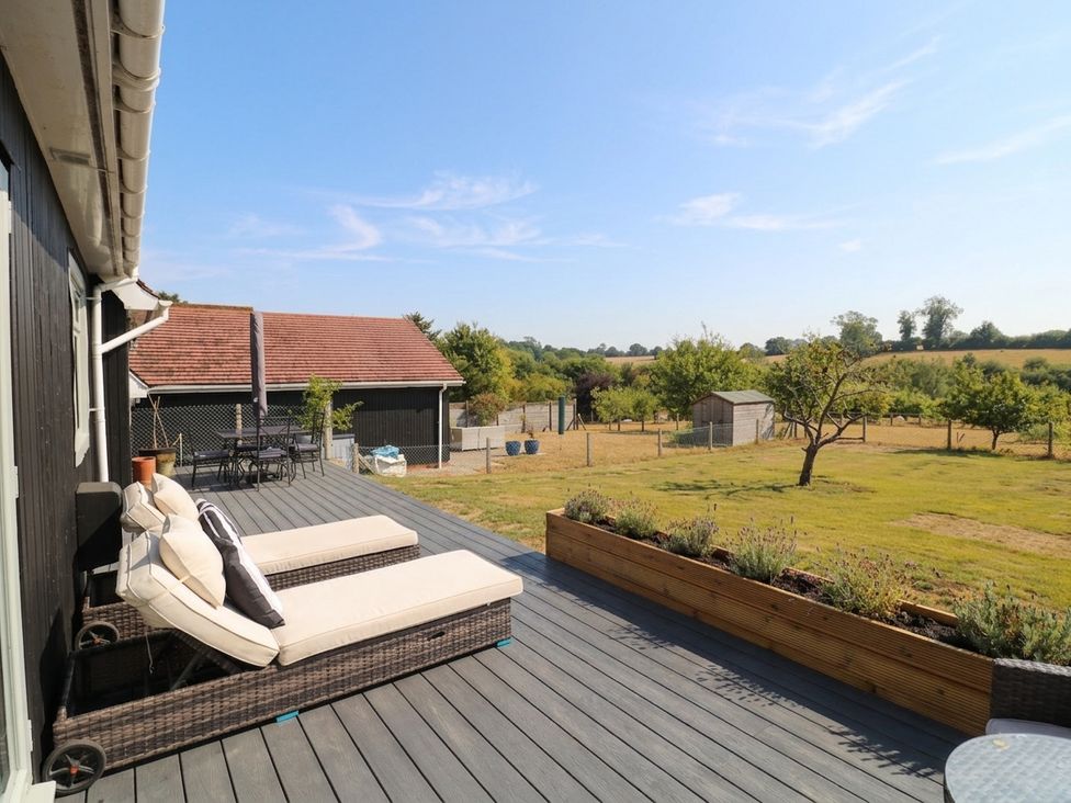 A deck area with lounge chairs and a table at 3 Swedish House Walgrave
