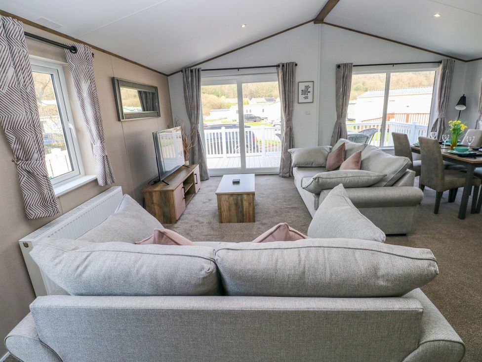 A living room with a sofa and coffee table at Dukes Meadow in Carmarthen