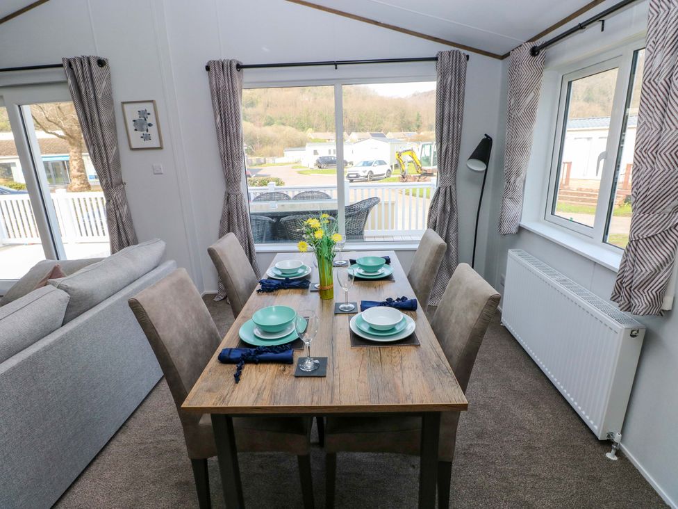 A dining area with a table and chairs at Dukes Meadow in Carmarthen