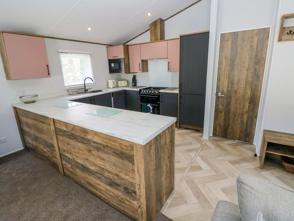 A kitchen with modern cabinets and appliances at Dukes Meadow in Carmarthen