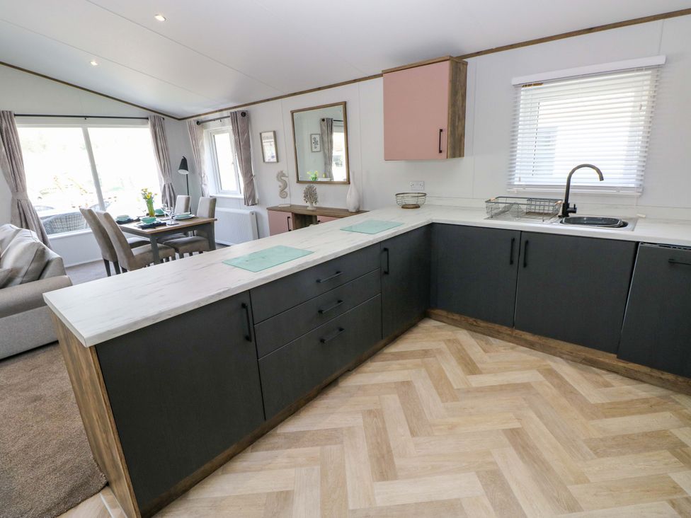 A kitchen with a sink and cabinetry at Dukes Meadow, Carmarthen