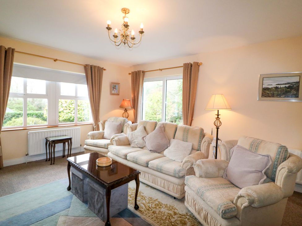 A living room with a sofa and coffee table at Lugdine Lodge in Glengarriff