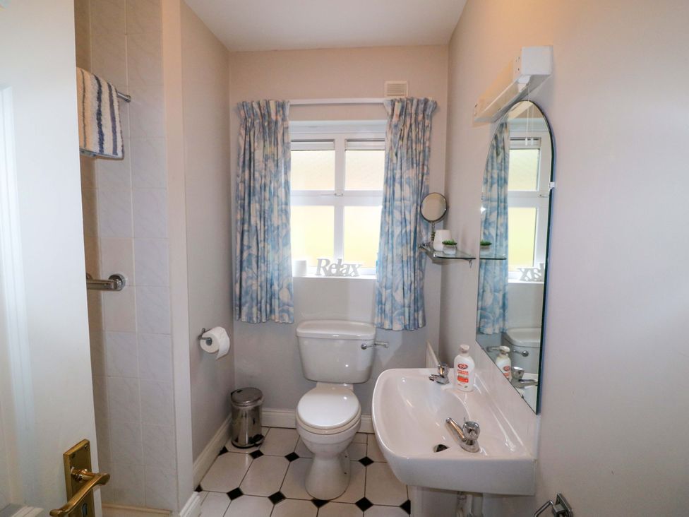A bathroom with a sink and toilet at Lugdine Lodge in Glengarriff
