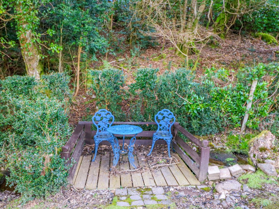 A seating area with blue chairs and a table at Lugdine Lodge Glengarriff
