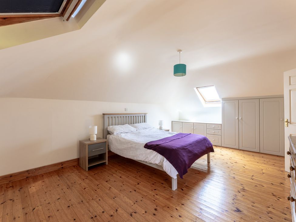 A bedroom with a double bed and lamp at Ballyneill Farmhouse in Carrick-On-Suir, County Tipperary