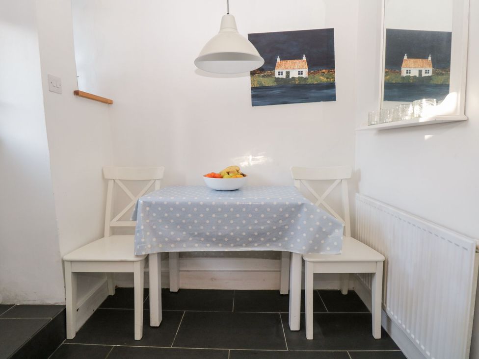 A dining area with a table and chairs at Burnside Cottage in Grange-Over-Sands