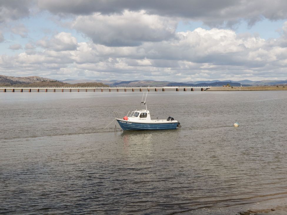 A boat in the water near a bridge at Burnside Cottage Grange-Over-Sands
