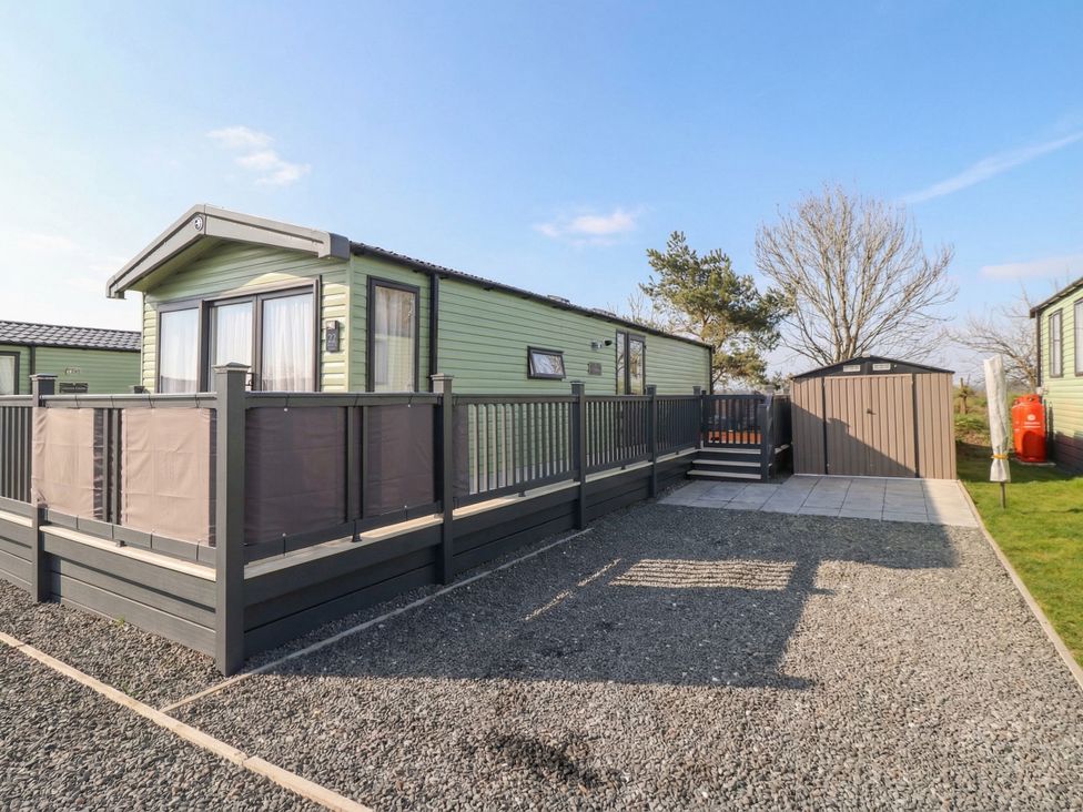 A mobile home with a deck and storage shed at Lodge 22, Moselle Malton