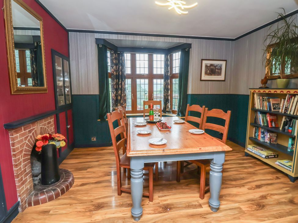 A dining room with a table and chairs at West Down Country House in South Molton