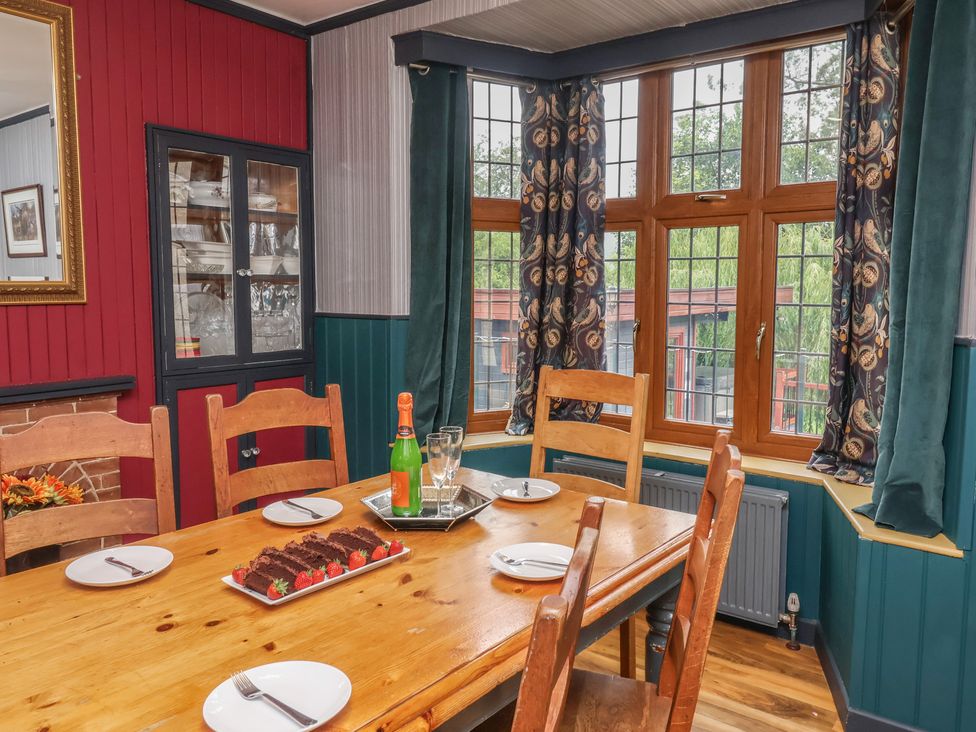A dining room with a table set for dessert at West Down Country House in South Molton