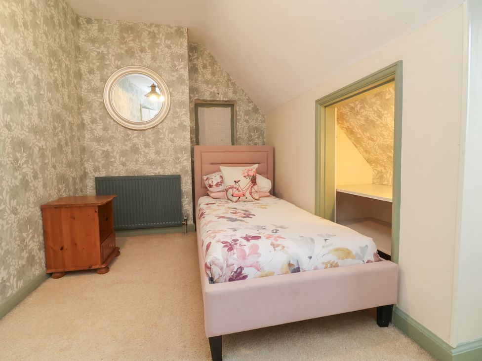 A bedroom with a bed and bedside table at West Down Country House in South Molton