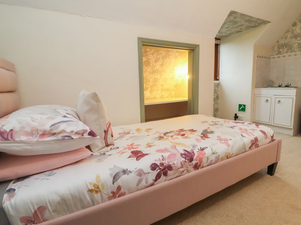 A bedroom with a bed and cabinet at West Down Country House in South Molton
