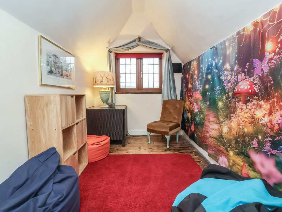 A seating area with bean bags and a shelf at West Down Country House in South Molton