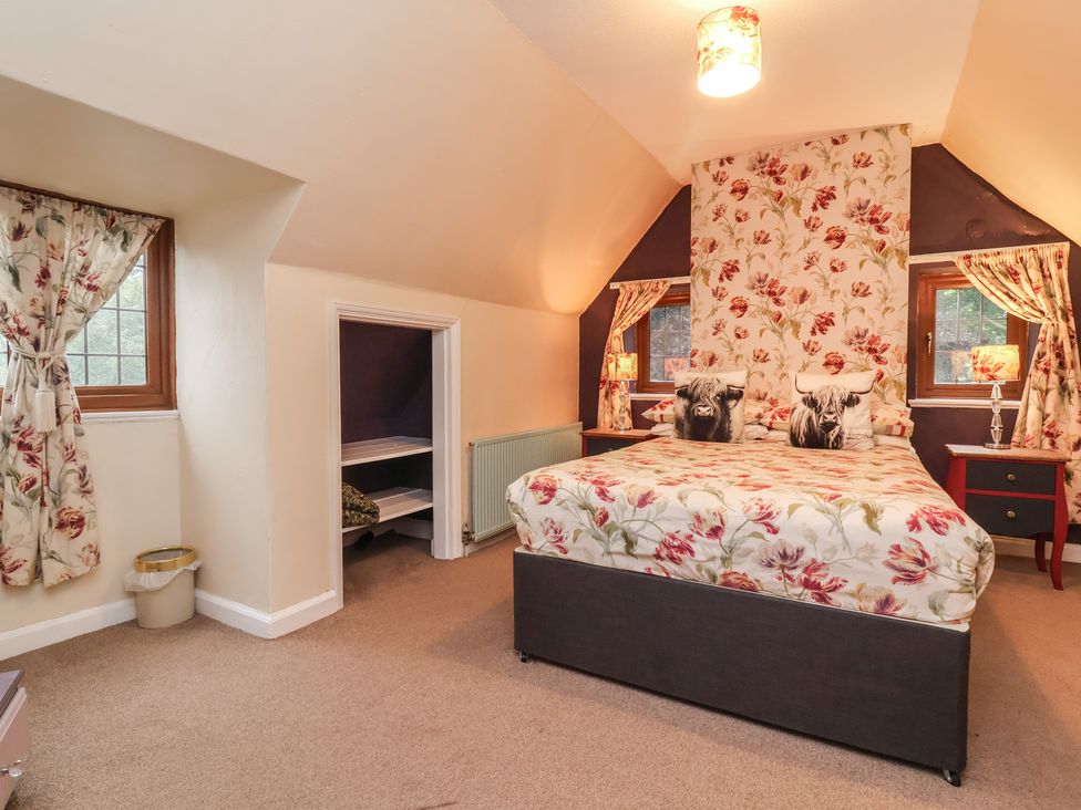 A bedroom with a bed and bedside tables at West Down Country House in South Molton