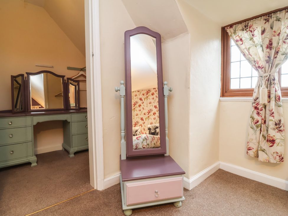 A bedroom with a mirror and dressing table at West Down Country House in South Molton