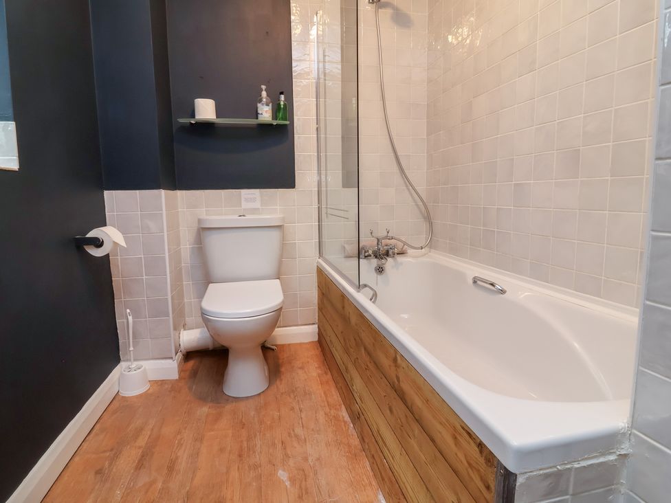 A bathroom with a bathtub and toilet at West Down Country House in South Molton
