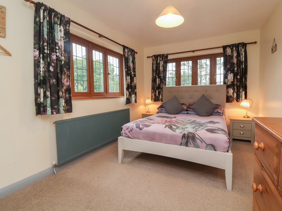 A bedroom with a bed and chest of drawers at West Down Country House in South Molton