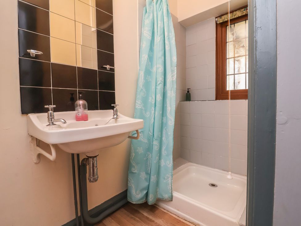 A bathroom with a sink and shower at West Down Country House in South Molton