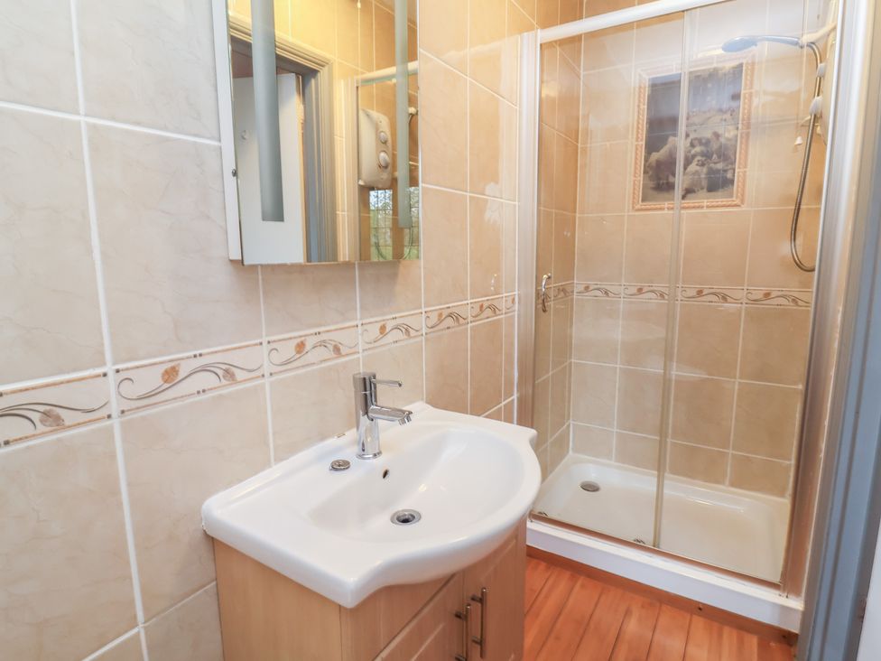 A bathroom with a sink and shower at West Down Country House in South Molton