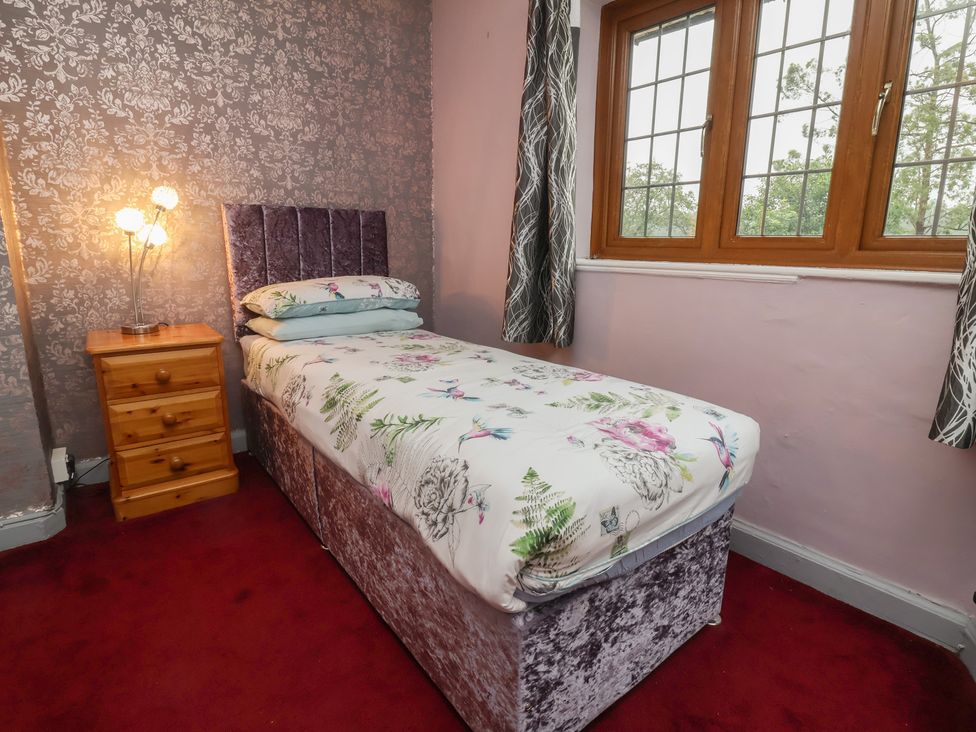 A bedroom with a single bed and bedside table at West Down Country House in South Molton