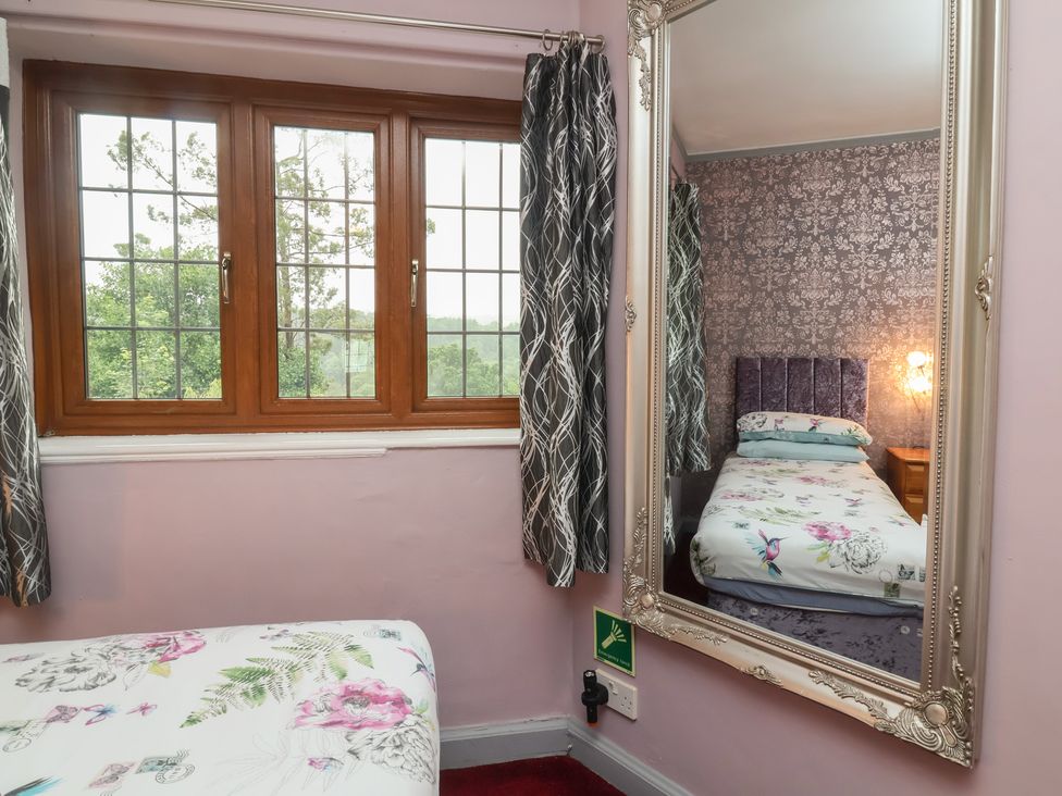 A bedroom with a bed and window at West Down Country House in South Molton