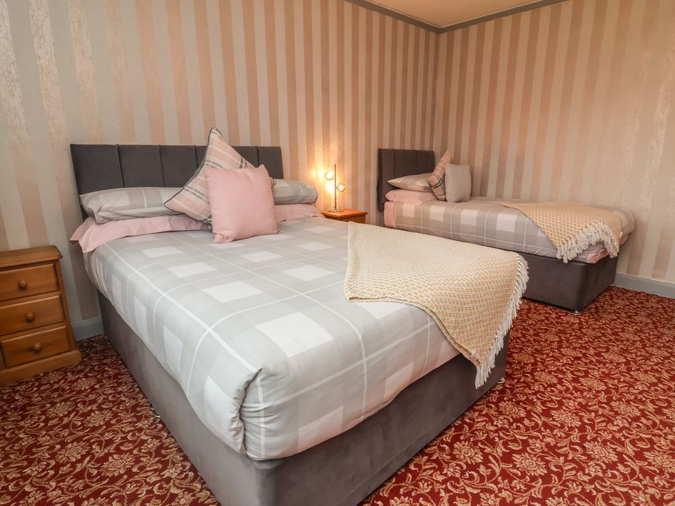 A bedroom with two beds and furniture at West Down Country House in South Molton