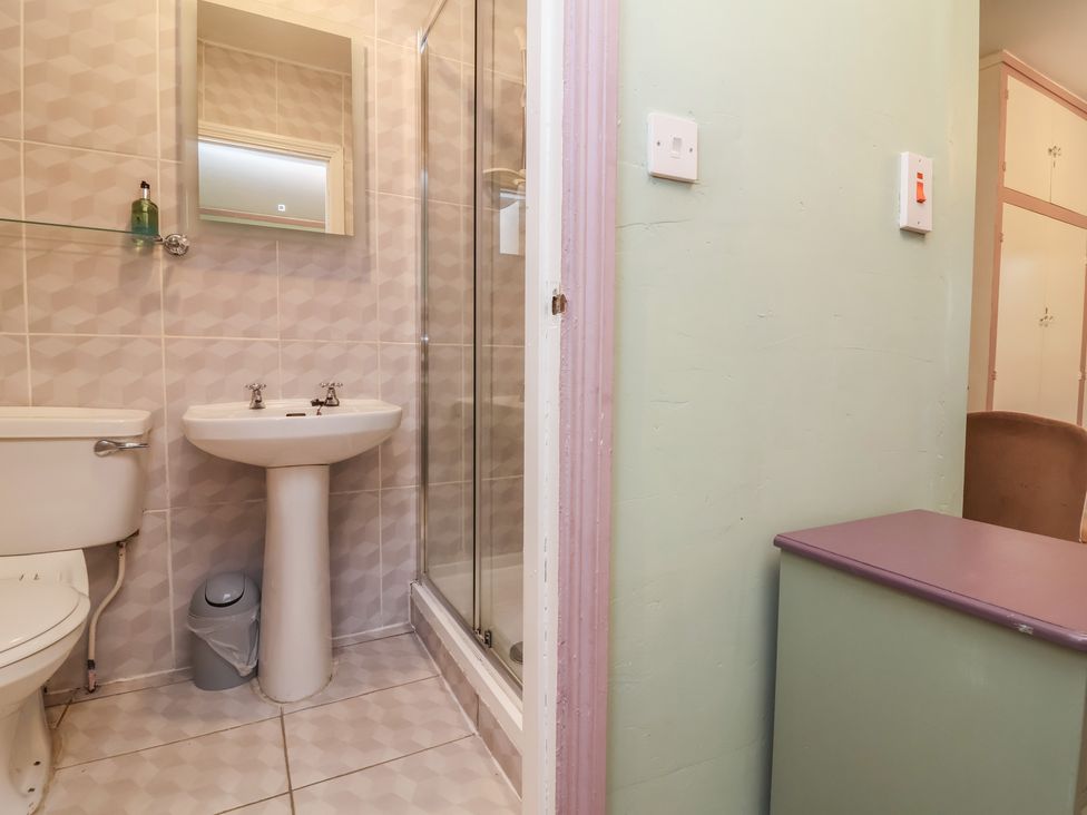 A bathroom with a shower and sink at West Down Country House in South Molton