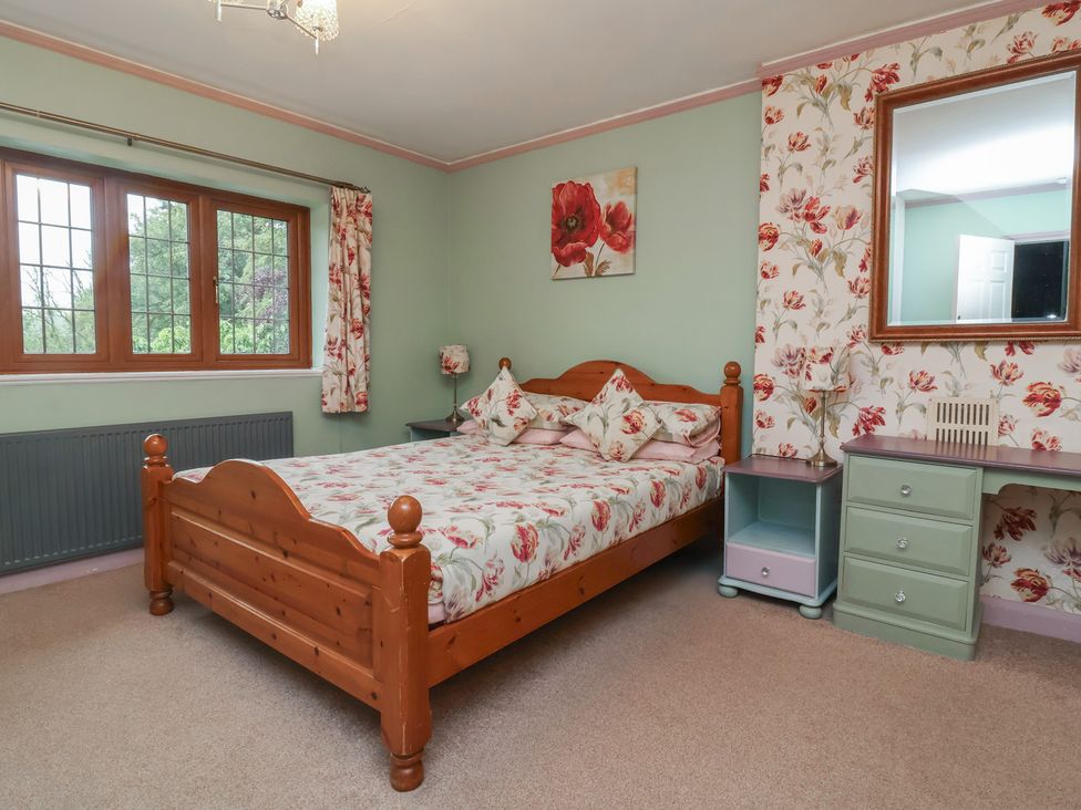 A bedroom with a bed and desk at West Down Country House South Molton