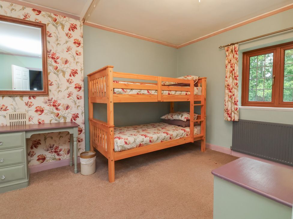 A bedroom with a bunk bed and a desk at West Down Country House in South Molton