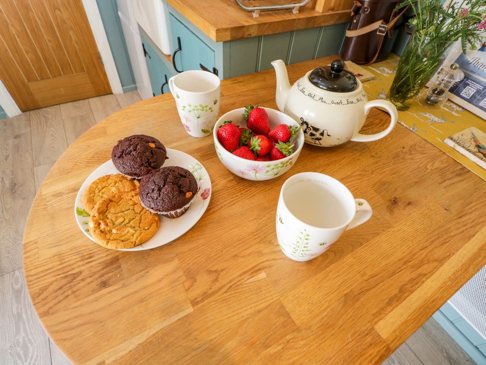 A tea set with muffins and strawberries at Daisy Shepherd's Hut in South Molton