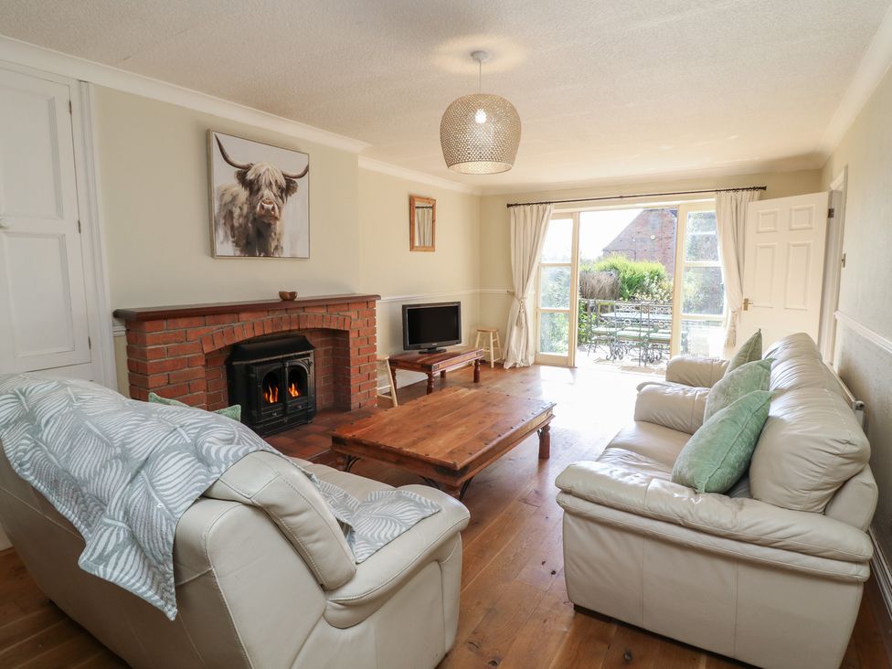 A living room with a fireplace and sofa at Highfields