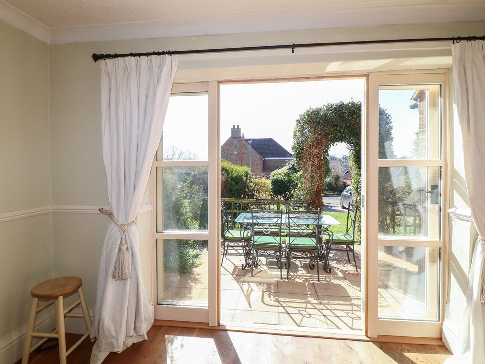 A dining room with a view of the garden at Highfields