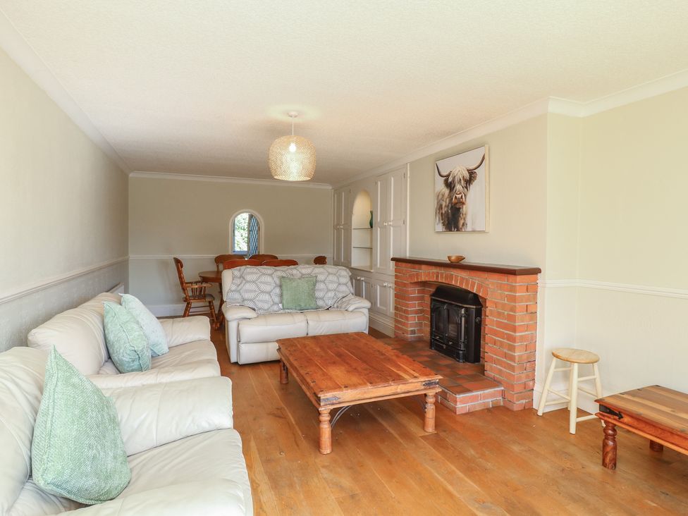 A living room with a coffee table and fireplace at Highfields