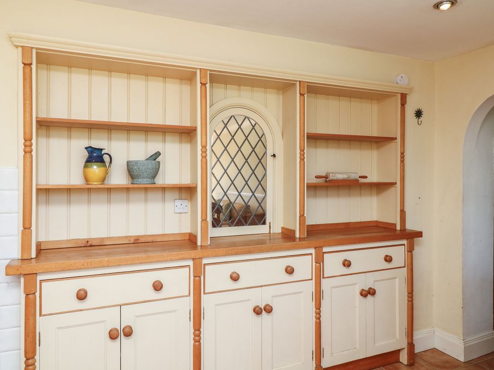 A kitchen with shelves and decorative items at Highfields
