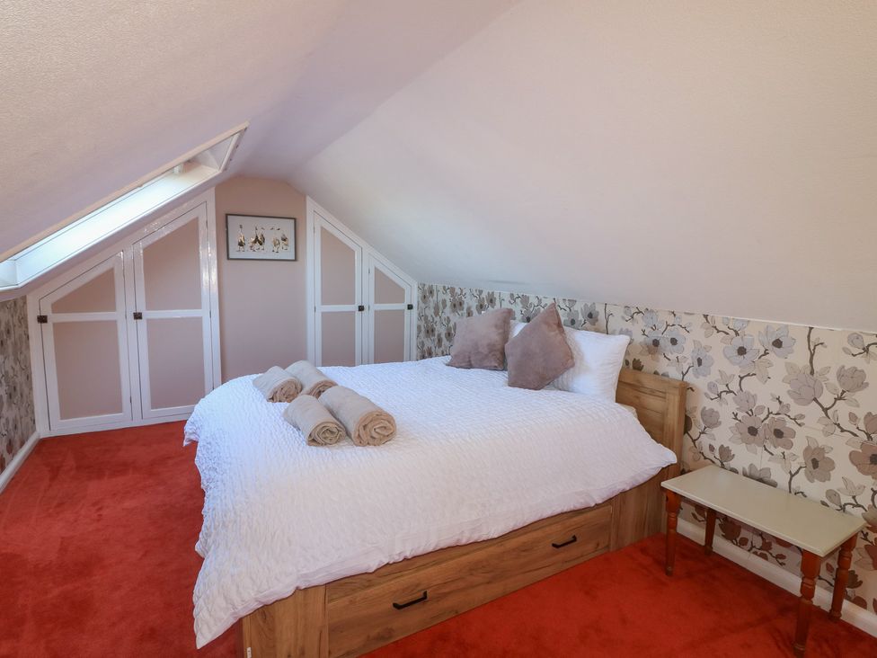 A bedroom with a bed and bedside table at Highfields