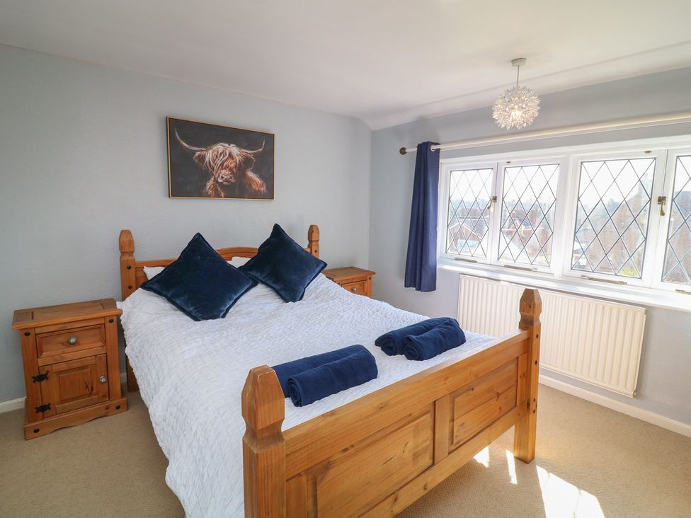 A bedroom with a bed and nightstands at Highfields