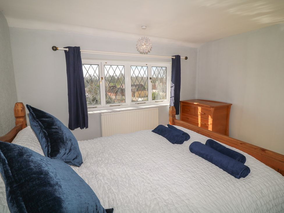 A bedroom with a bed and dresser at Highfields