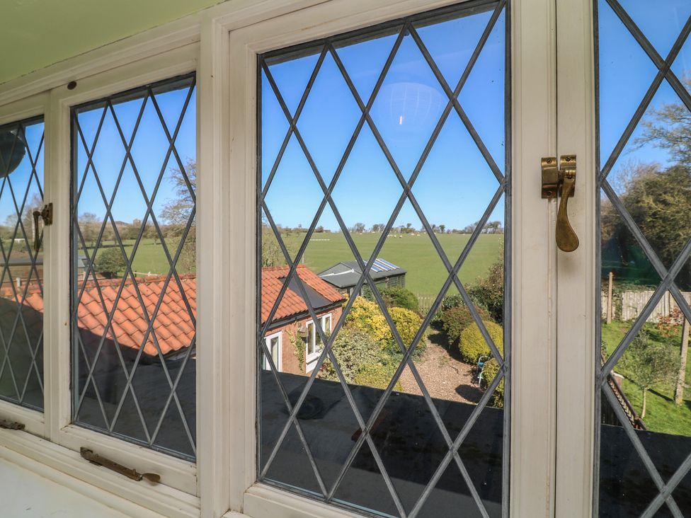 A view from a window showing a field and garden at Highfields