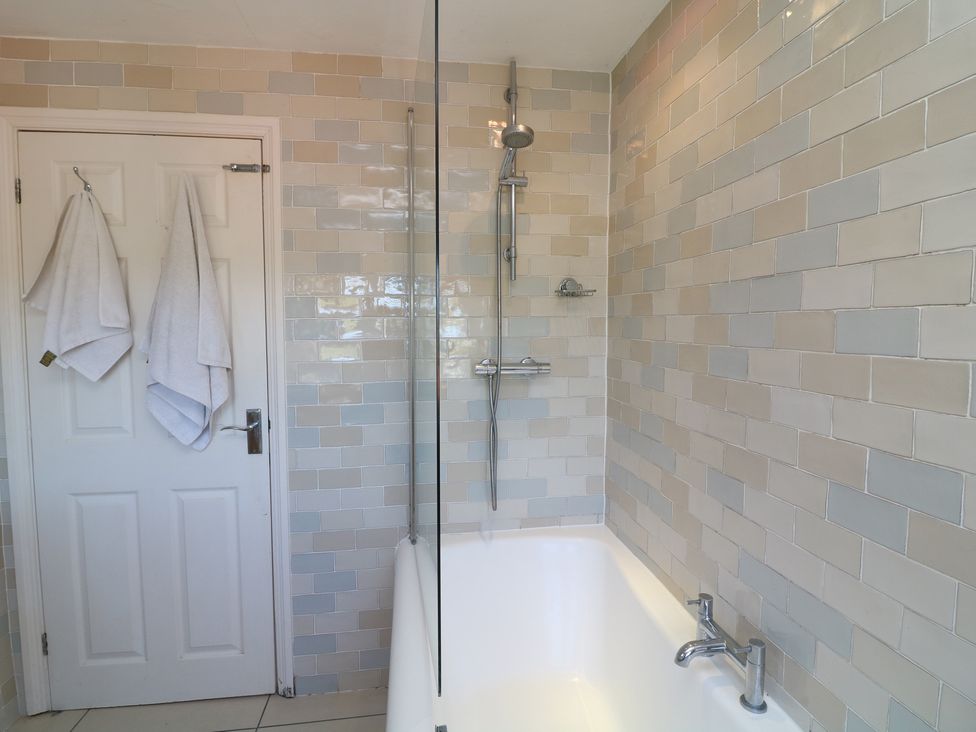 A bathroom with a bathtub and shower at Highfields