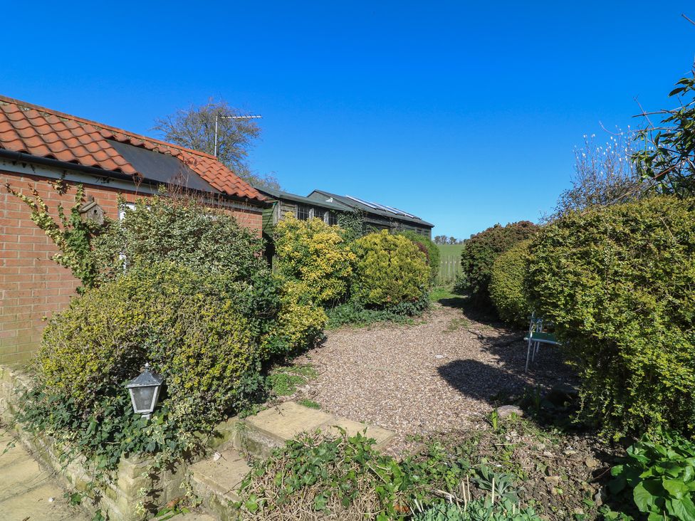 A garden with bushes and a pathway at Highfields 