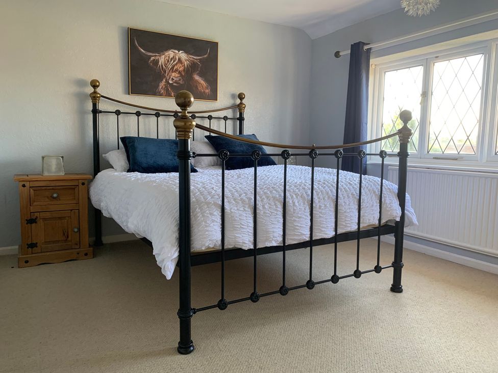 A bedroom with a bed and nightstand at Highfields in Caunton near Southwell