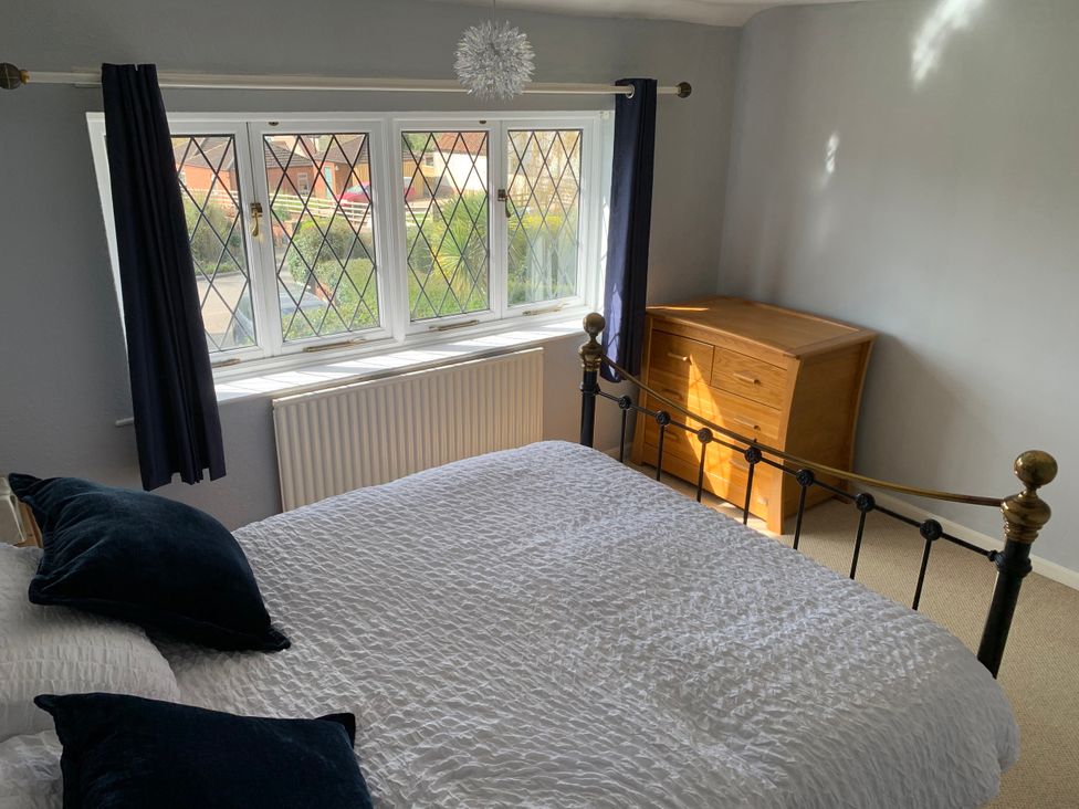 A bedroom with a bed and window at Highfields in Caunton near Southwell